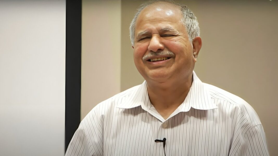 A smiling elderly man, often called the father of AI in India